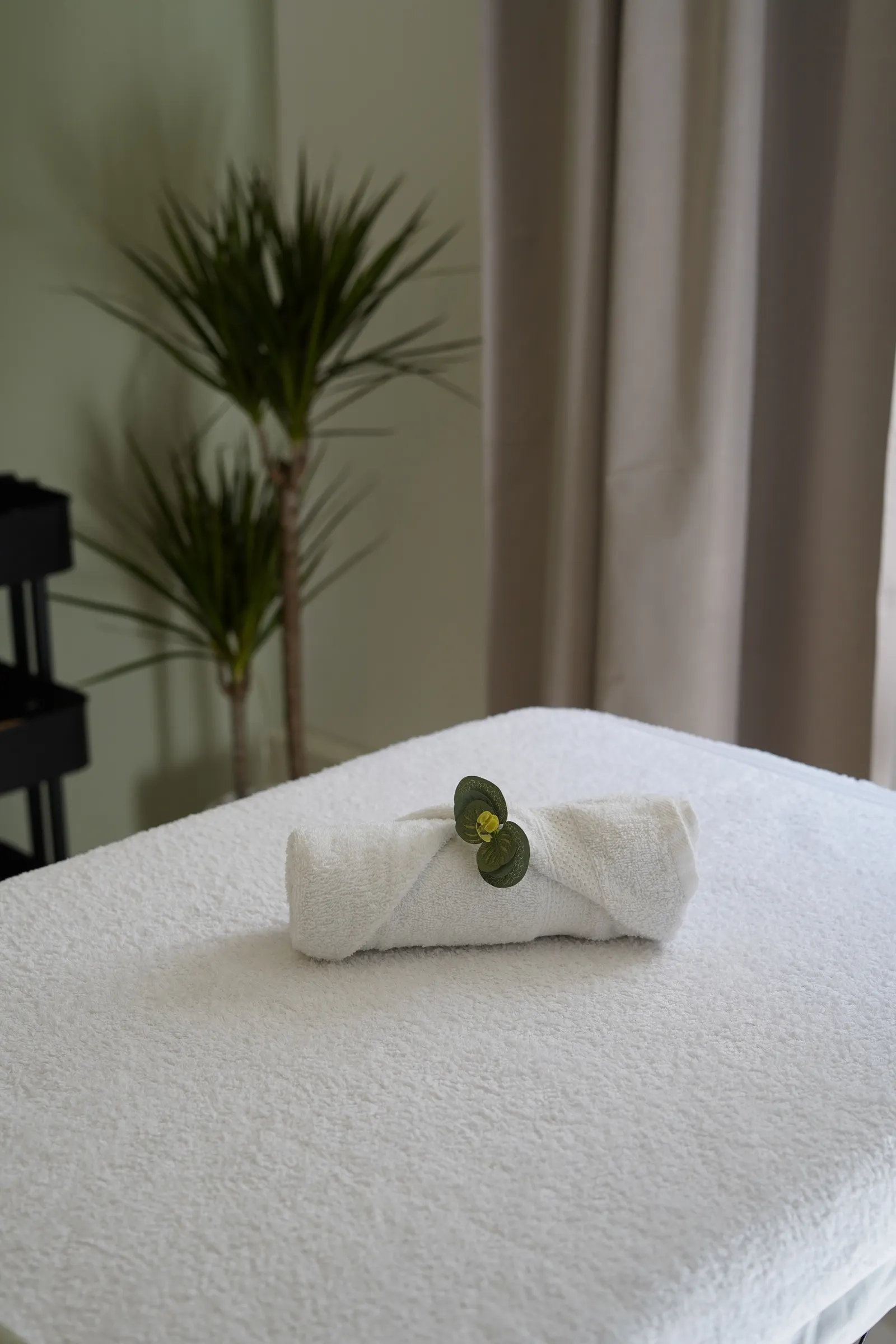 Portable massage table prepared for deep tissue treatment with clear space around it