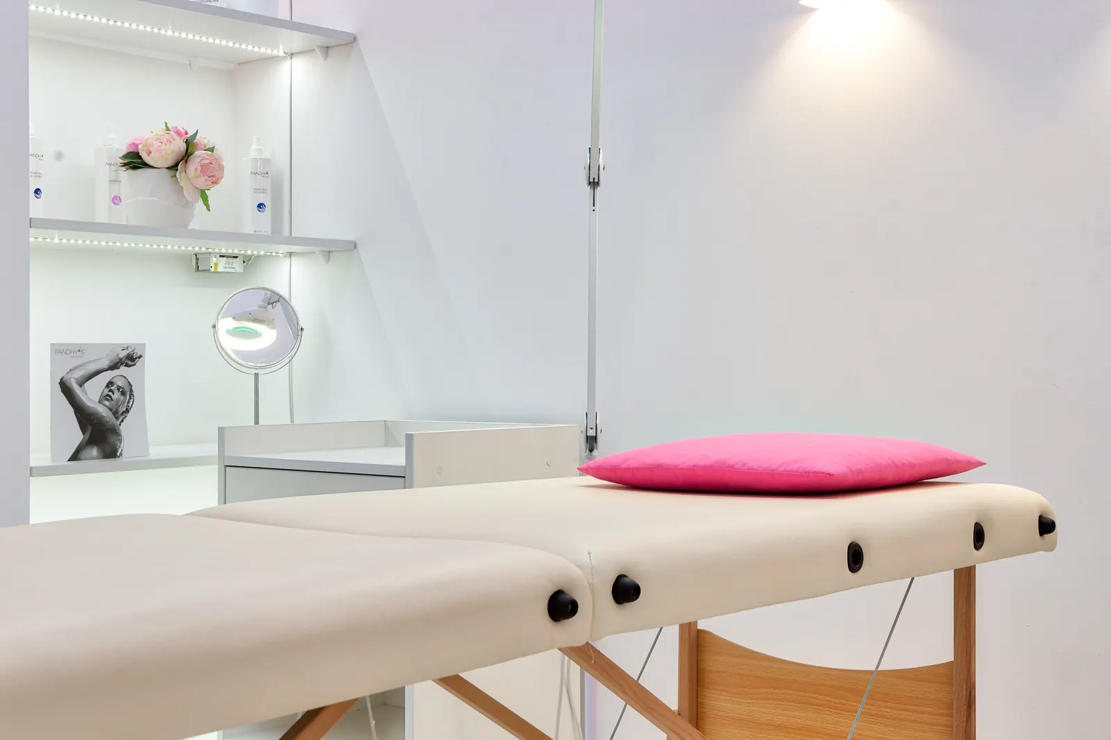 Pregnancy-aware mobile massage setup with side-lying cushions and fresh towels in a calm London room